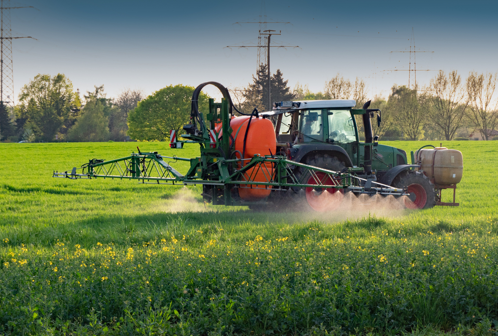 Tractor,With,Sprayer,Works,On,A,Field