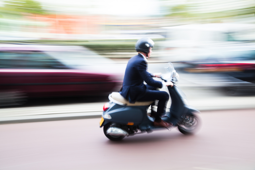 Scooter,Rider,On,A,Bike,Lane,In,The,Busy,City