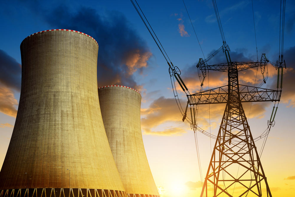 Nuclear,Power,Plant,With,High,Voltage,Towers,Against,The,Sunset