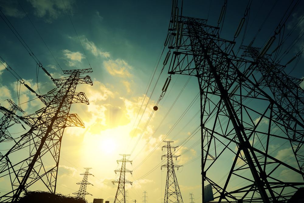 High-voltage,Power,Transmission,Towers,In,Sunset,Sky,Background