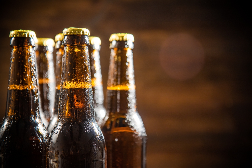 Fresh,Beer,In,Closed,Bottles.,On,Rustic,Background.