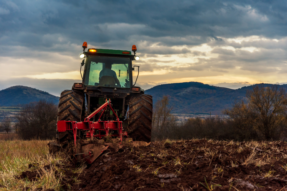 Farmer,In,Tractor,Preparing,Land,With,Cultivator,At,Night.
