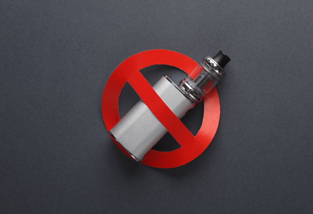 Vaping,Device,With,A,Prohibition,Sign,On,Dark,Background.,Smoking