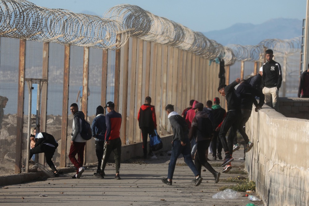 Migrants cross from Morocco into Ceuta, Spain