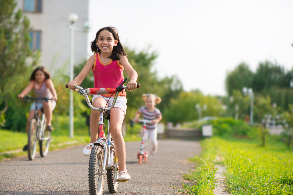 Three,Happy,Children,Riding,On,Bicycle