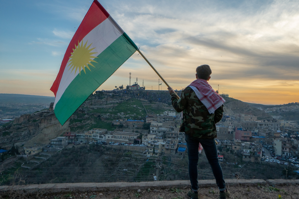 Teenager,Holding,The,Kurdistan,Flag,In,Northern,Iraq,At,Sunset