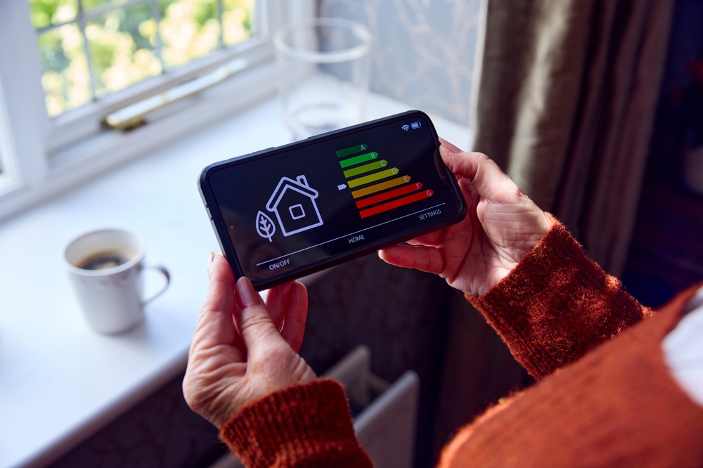Senior,Woman,With,Smart,Meter,Trying,To,Keep,Warm,By