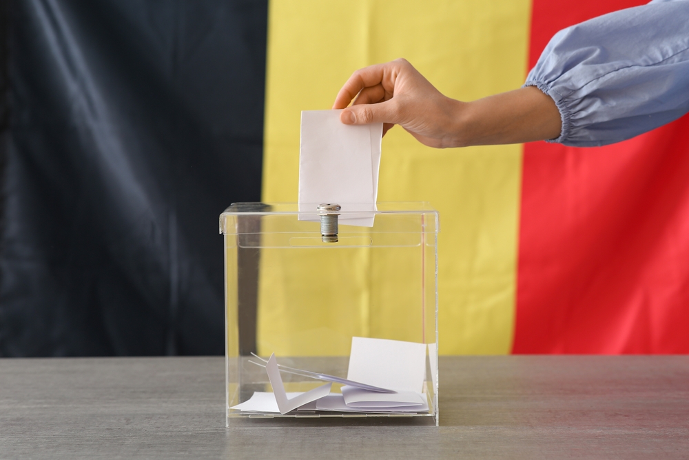 Voting,Woman,With,Belgium,Flag,Near,Ballot,Box,On,Table