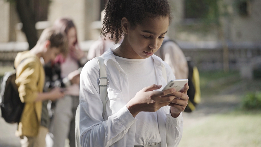 Unhappy,African,American,School,Girl,Scrolling,Smartphone,Alone,,Social,Media