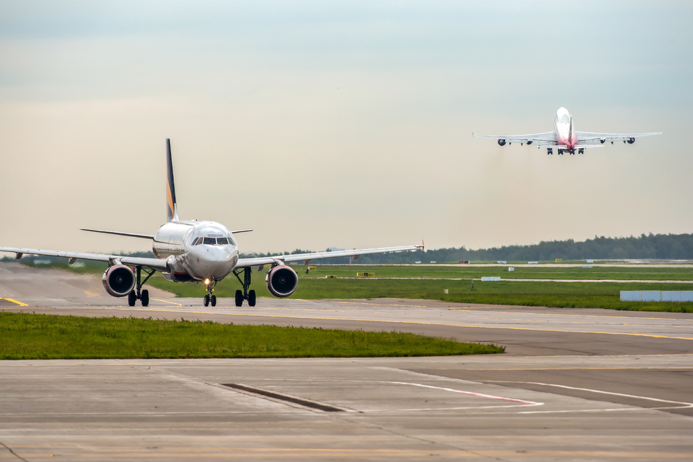 Modern,Passenger,Airplane,Taxiing,While,Big,Widebody,Aircraft,Taking,Off