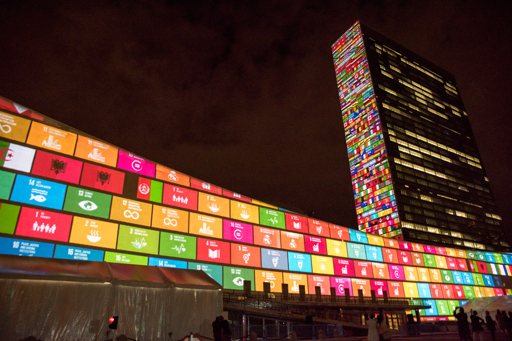 SDGs symbols, national flags and UN Headquarters