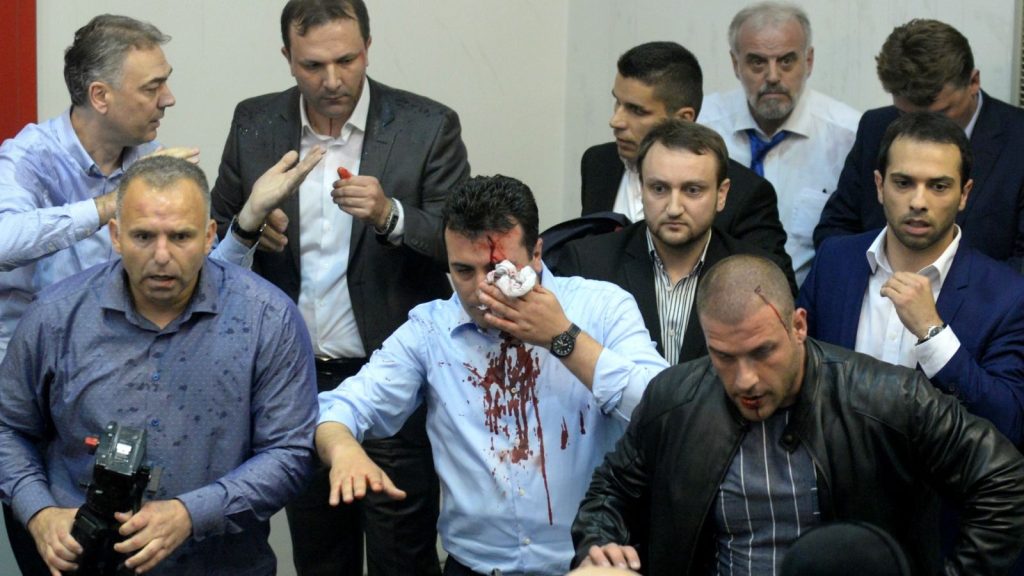 epa05931627 Zoran Zaev (C), the leader of Social Democratic Union of Macedonia with blood on his face tries to leave the Parliament after protestors attacked him after they stormed Macedonian Parliament in Skopje, The Former Yugoslav Republic of Macedonia on 27 April 2017. President Ivanov didn’t give the mandate for a new government, although Zoran Zaev (the leader of SDSM) provided a list of signatures, guaranteeing parliamentary majority he rejected giving him the mandate with explanation that the coalition between Zaev and the Albanian parties (with their platform for two official languages in the country) would destroy the constitutional order in the country.  EPA/STR