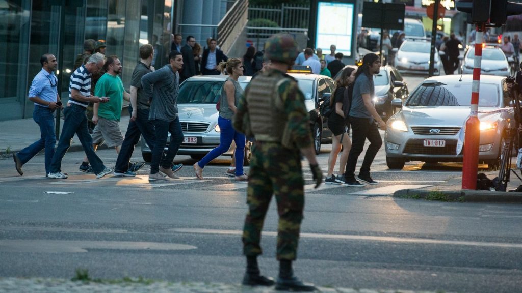 epa06039904 People walk past an armed soldier outside of the Brussels Central Station after a neutralized terrorist attack attempt, in Brussels, Belgium, 20 June 2017. According to Belgian media, police shot a suspect wearing an explosive belt at the Brussels Central Station. Belgian police also confirmed there was a small explosion in the Brussels Central Station, but said there are not much damage done and situation is under control. The cause of the explosion is unknown.  EPA/STEPHANIE LECOCQ