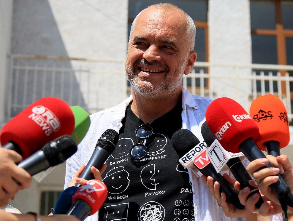 epa06049326 Albanian Prime Minister Edi Rama speaks to the media after casting his vote in a polling station near Tirana, Albania, 25 June 2017. Albanians head to the polls on 25 June for parliamentary elections.  EPA/MALTON DIBRA