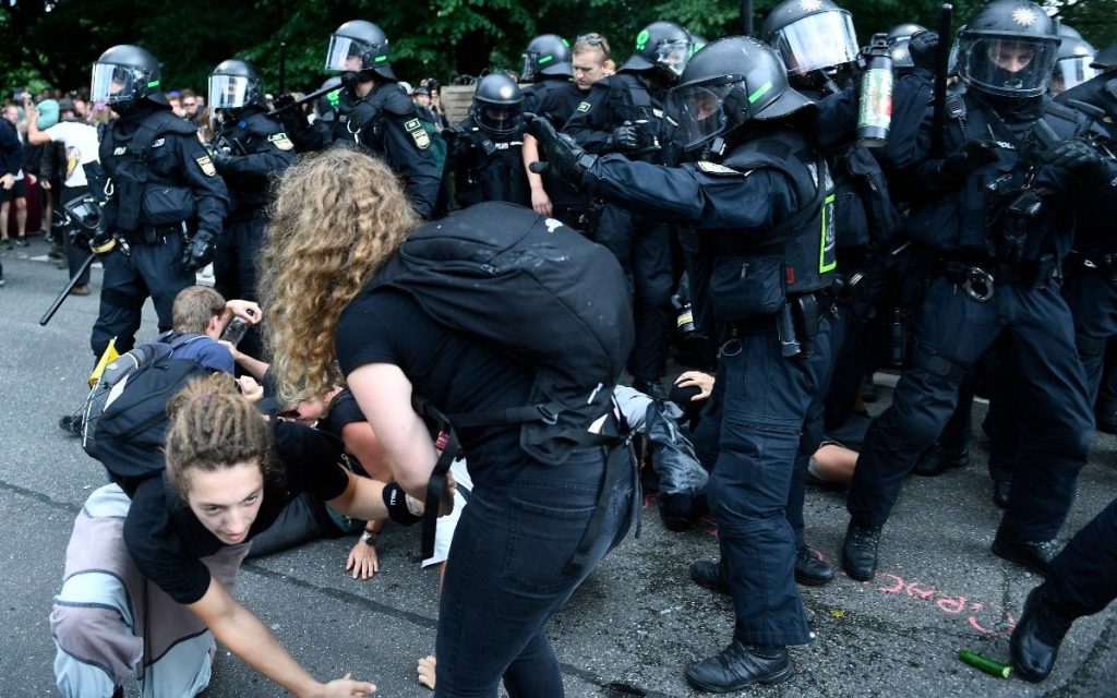 epa06076462 Riot police scuffle with protesters a protests against the G20 summit in Hamburg, Germany, 08 July 2017. The G20 Summit (or G-20 or Group of Twenty) is an international forum for governments from 20 major economies. The summit is taking place in Hamburg 07 to 08 July 2017.  EPA/FILIP SINGER