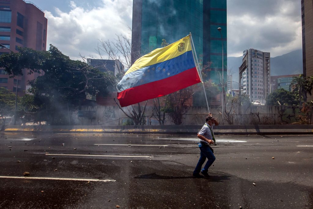 Demonstrators and police clash in opposition protests in Caracas