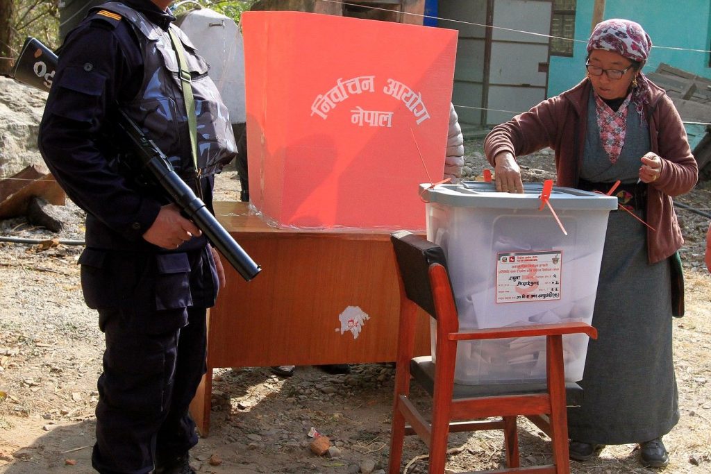 epa06351753 A woman casts her vote on a ballot box during the parliamentary and provincial elections in Rashuwa District, Nepal. 26 November2017. Nearly 3.5 million Nepalese are called to vote in the first round of general elections under the 2015 Constitution, ending 18 years of proxy in the legislature.  EPA-EFE/KIRAN PANDAY