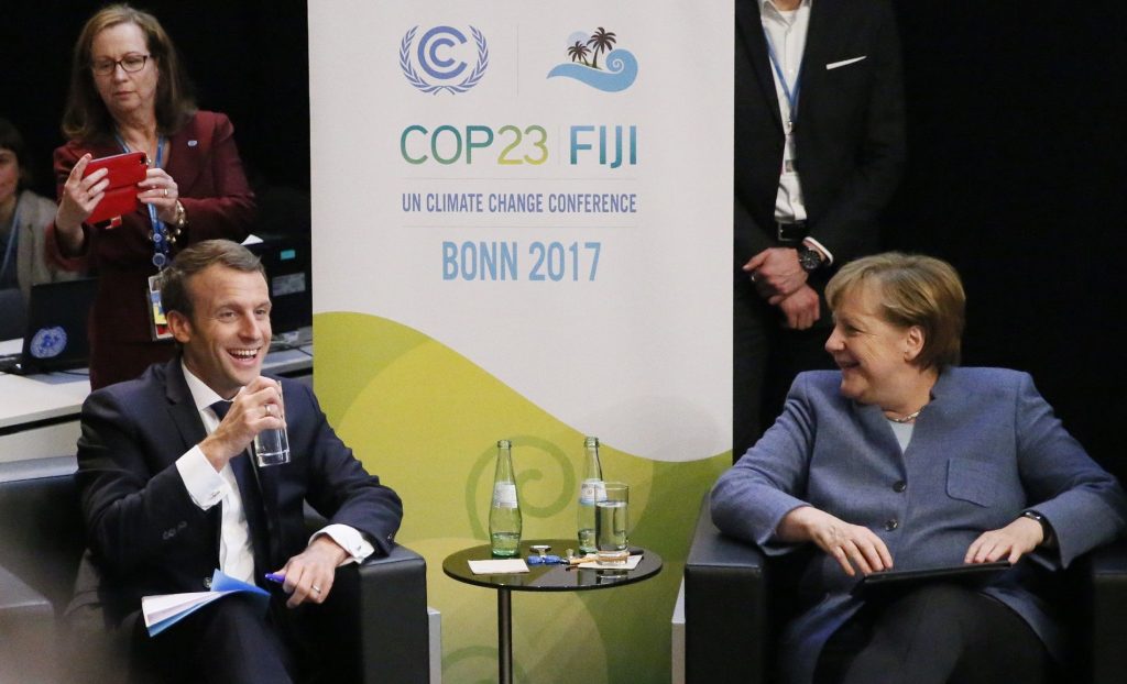 epa06331483 French President Emmanuel Macron (L) and Germany Chancellor Angela Merkel (R) speak during the UN Climate Change Conference COP23 in Bonn, Germany, 15 November 2017. The 23rd session of the United Nations Framework Convention on Climate Change Conference (UNFCCC), the 2017 UN Climate Change Conference COP23 will take place from 06 to 17 November in Bonn, the seat of the Climate Change Secretariat, under the presidency of Fiji.  EPA-EFE/RONALD WITTEK