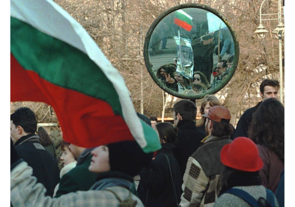 Opposition supporters are mirrored in a traffic mirror as they march during a demonstration through downtown Sofia, 25 January. Hundreds of protesters gathered again on the streets of the Bulgarian capital demanding fast political changes. The talks between Bulgaria’s ruling Socialists and opposition leaders aimed at defusing the country’s political crisis ended in failure yesterday, almost as soon as they had begun.