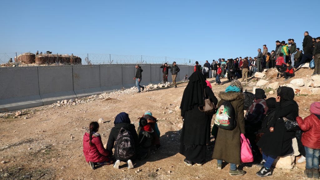 epaselect epa08188231 Syrian people gather near the Syrian-Turkish borders during a protest northwestern of Idlib, Syria, 02 February 2020. According to local reports, some 500 people joined the protest titled ‚From Idlib to Berlin‘ organized by several civilian activists in northern Syria to highlight the sufferings of Idlib residents after the Syrian regime launched operation and escalated airstrikes on the area. According to one of the organizers, the protesting people are calling on Turkey to open safe passages so that civilians can cross to European countries, namely Germany which had previously received Syrian refugees.  EPA-EFE/YAHYA NEMAH