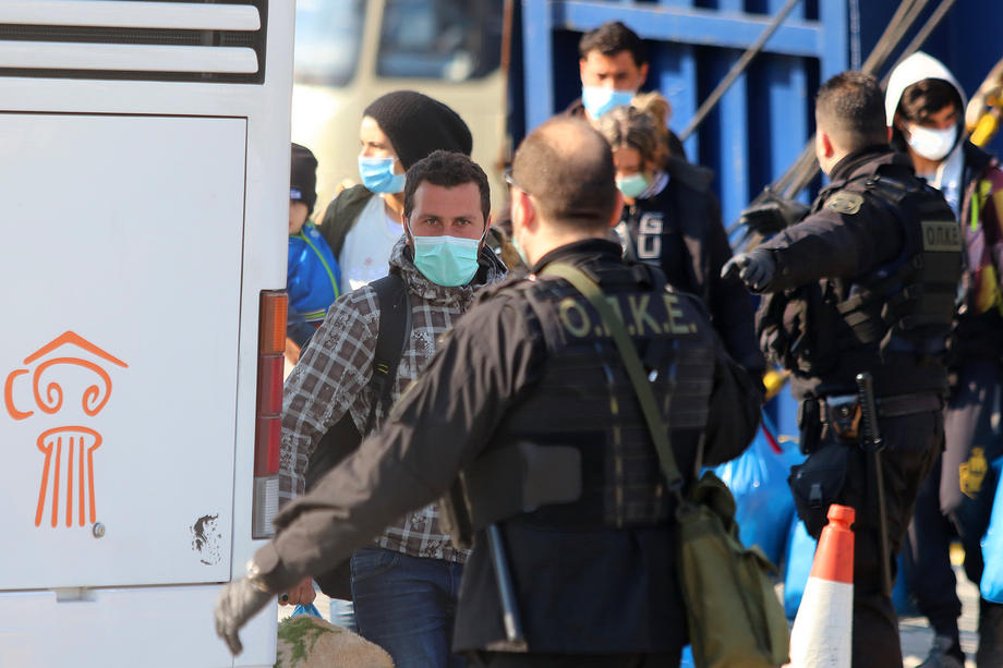 Asylum seekers disembark from a ferry arriving from Lesvos and other islands of the north Aegean Sea