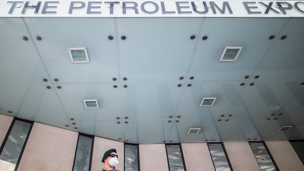 epa08353329 An Austrian Armed Forces soldier wearing a face mask patrols in front of the Organization of Petroleum Exporting Countries (OPEC) headquarters in Vienna, Austria, 09 April 2020. According to reports Ministers of the OPEC member states discuss SARS-CoV-2 coronavirus, which causes the Covid-19 disease, effects on the oil business in a video conference today.  EPA-EFE/CHRISTIAN BRUNA