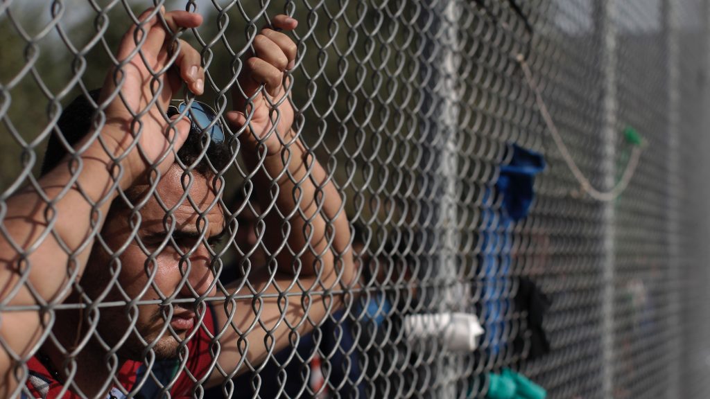 epa04973189 A photo made available on 11 October 2015 shows a man waiting to be registered in a camp set up for migrants near the village of Moria on the island of Lesbos, Greece, 10 October 2015. A recently agreed European Union plan to relocate tens of thousands of asylum seekers from Italy and Greece elsewhere in the bloc will start at the end of this week, a top EU official said 06 October. Lesbos – the third-largest Greek island and home to nearly 90,000 people – has been overwhelmed with migrants from Syria, Afghanistan and Iraq trying to reach Europe. More than 200,000 refugees arrived on the island this year alone, according to the UN refugee agency. Many of the refugees begin their journey to Lesbos across sparkling Aegean waters in Turkey.  EPA/YANNIS KOLESIDIS GREECE OUT