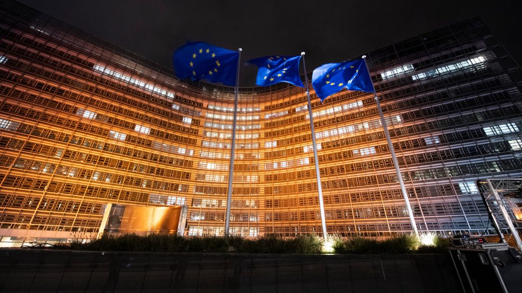 The Berlaymont building illuminated in orange, by night