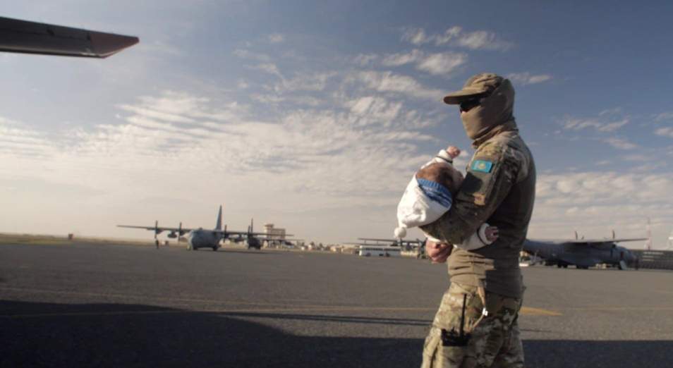 Kazakh military carries baby
