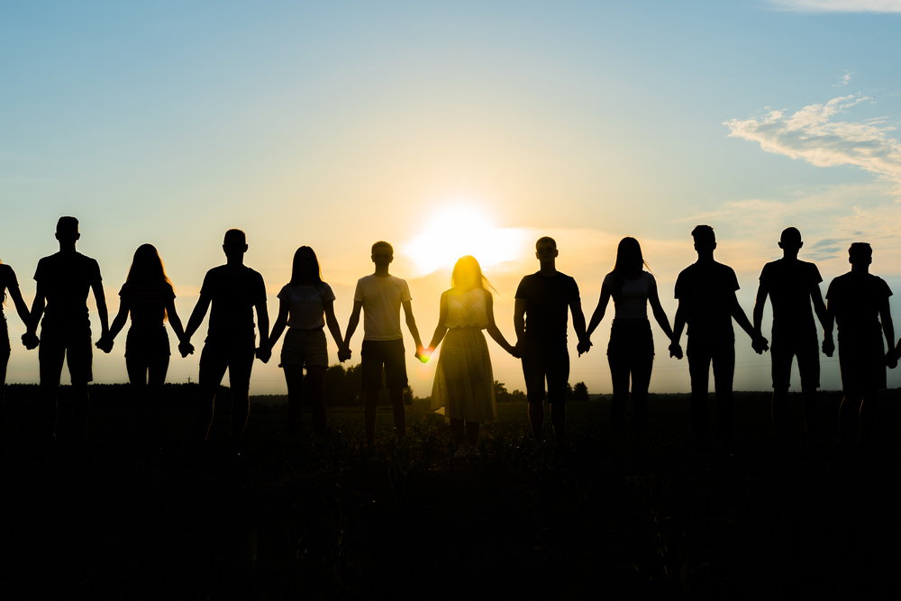 Cohesion,Concept.,Black,Silhouettes,Of,Friends,Holding,Hands,Stands,At