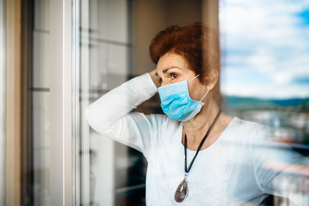 Senior,Elderly,Sad,Woman,At,Home,Looking,Through,The,Window.coronavirus