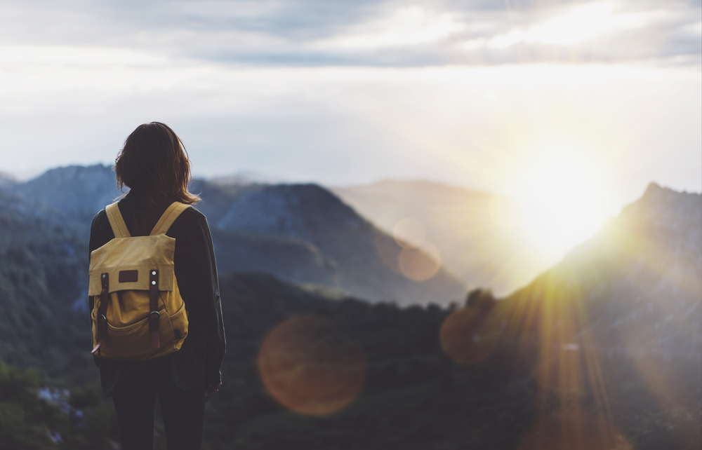 Hipster,Young,Girl,With,Backpack,Enjoying,Sunset,On,Peak,Of