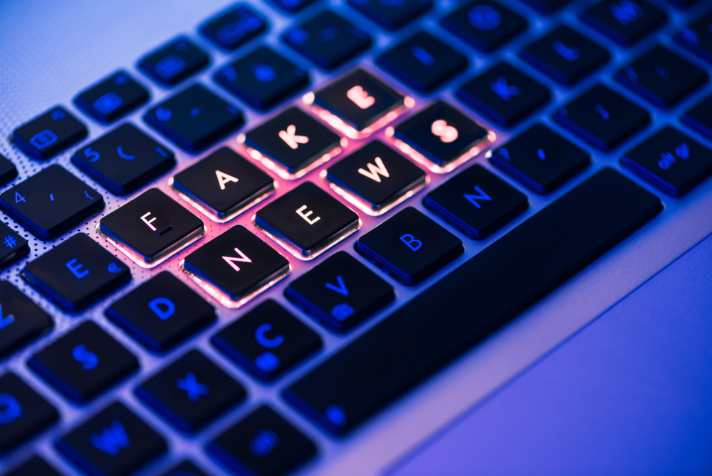 Fake,News,Written,In,Red,On,A,Backlit,Laptop,Keyboard