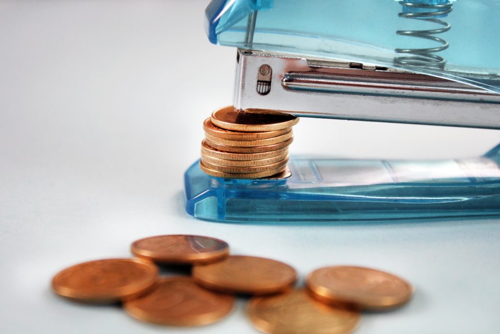 Gold,Coins,Stapled,,Stapler,And,Coins,,Financial,Crisis,Concept,Or