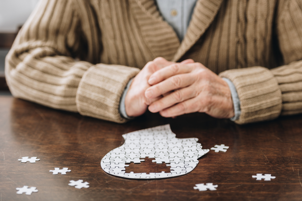 Cropped,View,Of,Senior,Man,Playing,With,Puzzles,On,Table