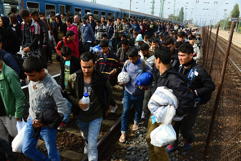 Group,Of,Refugees,Leaving,Hungary.,They,Came,To,Hegyeshalom,By