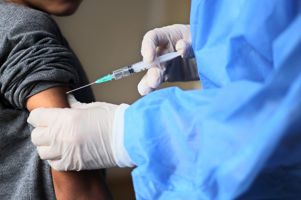 Pediatrician,Makes,Vaccination,To,Small,Boy.,Female,Doctor,Vaccinating,Little