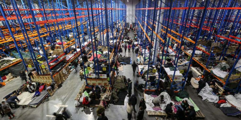 migrants in Belarus warehouse