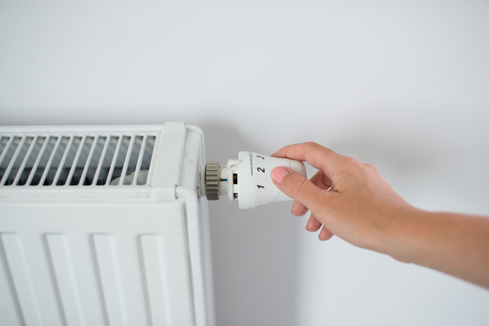 Woman,Hand,Adjusting,The,Knob,Of,Heating,Radiator.,The,Valve