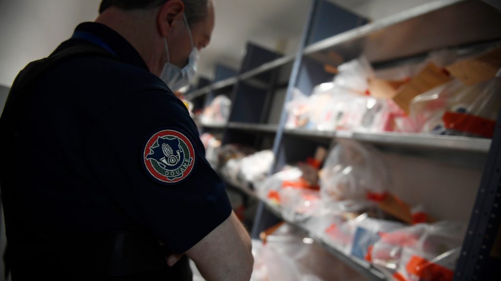 epa08541031 A custom officer looks the bag of seized illegal products in French Customs Police service  (Douanes), during the visit of French Junior Minister for Public Administration Olivier Dussopt, at the Paris Charles De Gaulle International Airport in Roissy, near Paris, France, 11 July 2020.  EPA-EFE/JULIEN DE ROSA