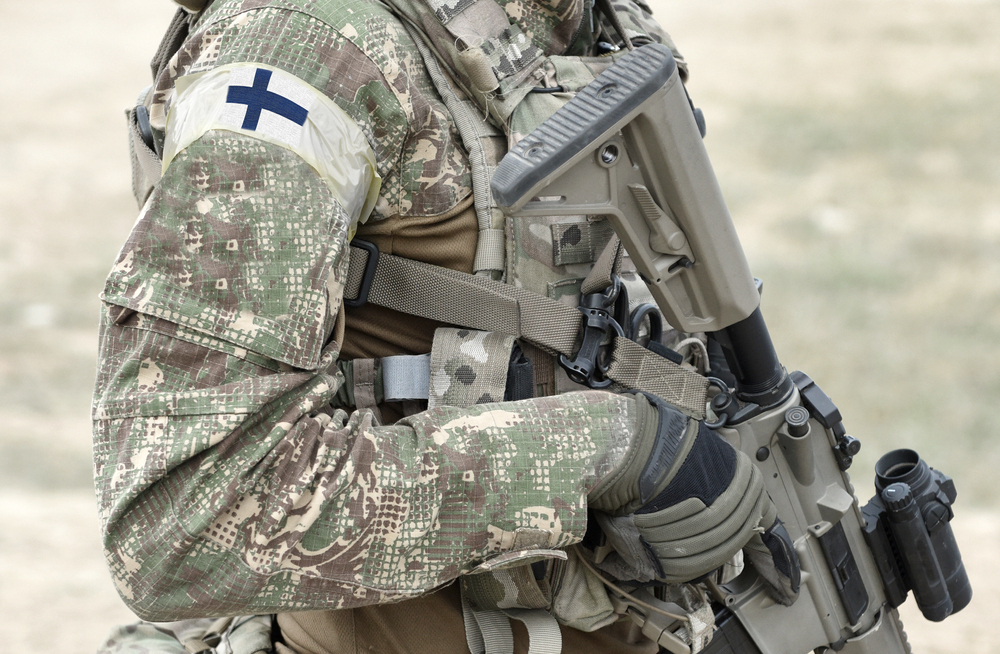 Soldier,With,Assault,Rifle,And,Flag,Of,Finland,On,Military