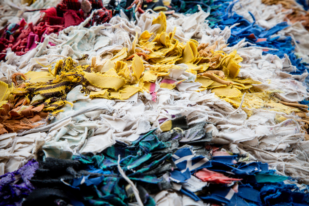 Fabric,Scraps,,Old,Clothing,And,Textiles,Are,Cut,Into,Strips