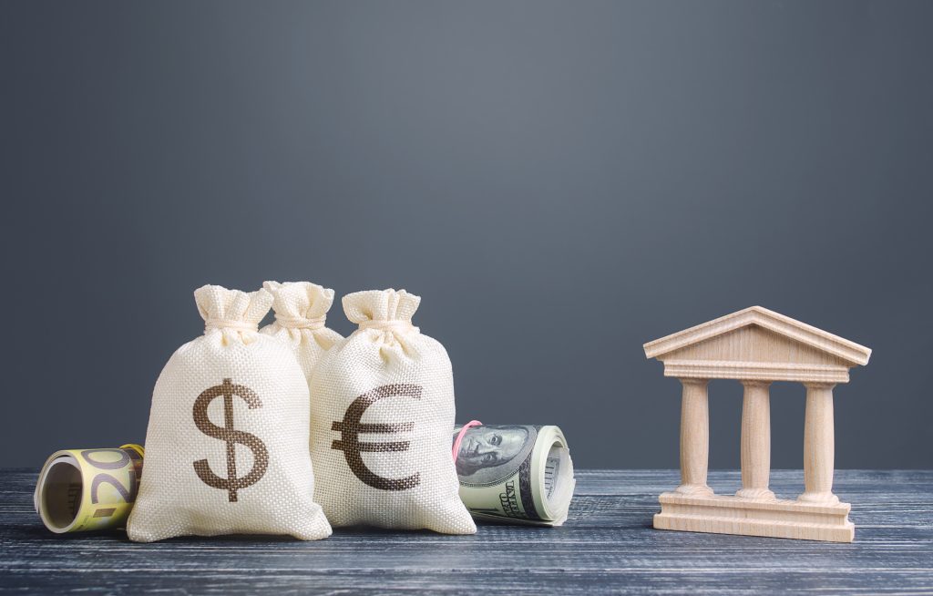 Money,Bags,And,A,Bank,Building.,Saving,Money,,Deposit.,National