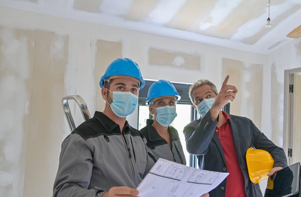 Professional,Meeting,On,A,Construction,Site,Between,The,Architect,And