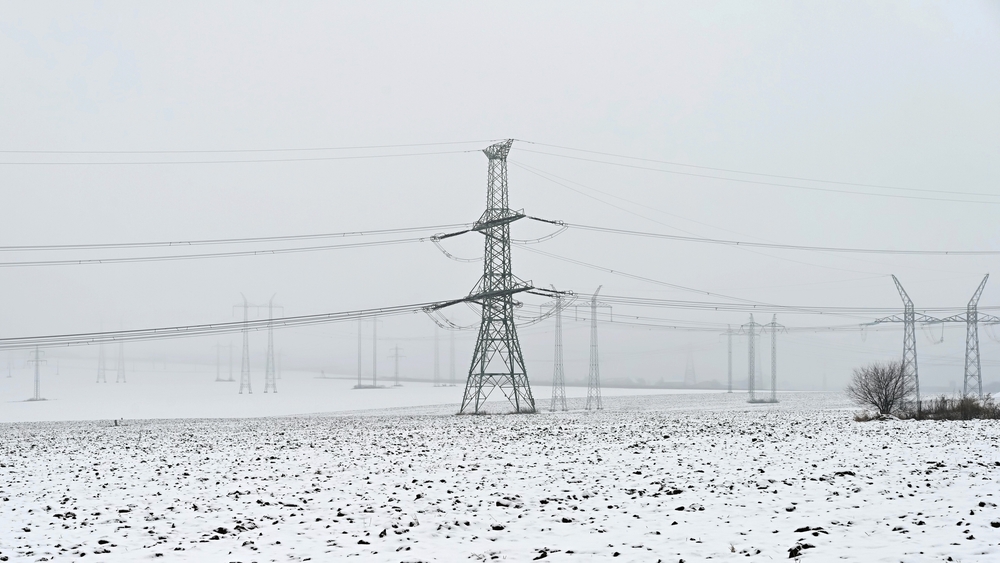 High,Voltage,Pylons,In,Winter,Landscape,With,Snow.,Expensive,Heating