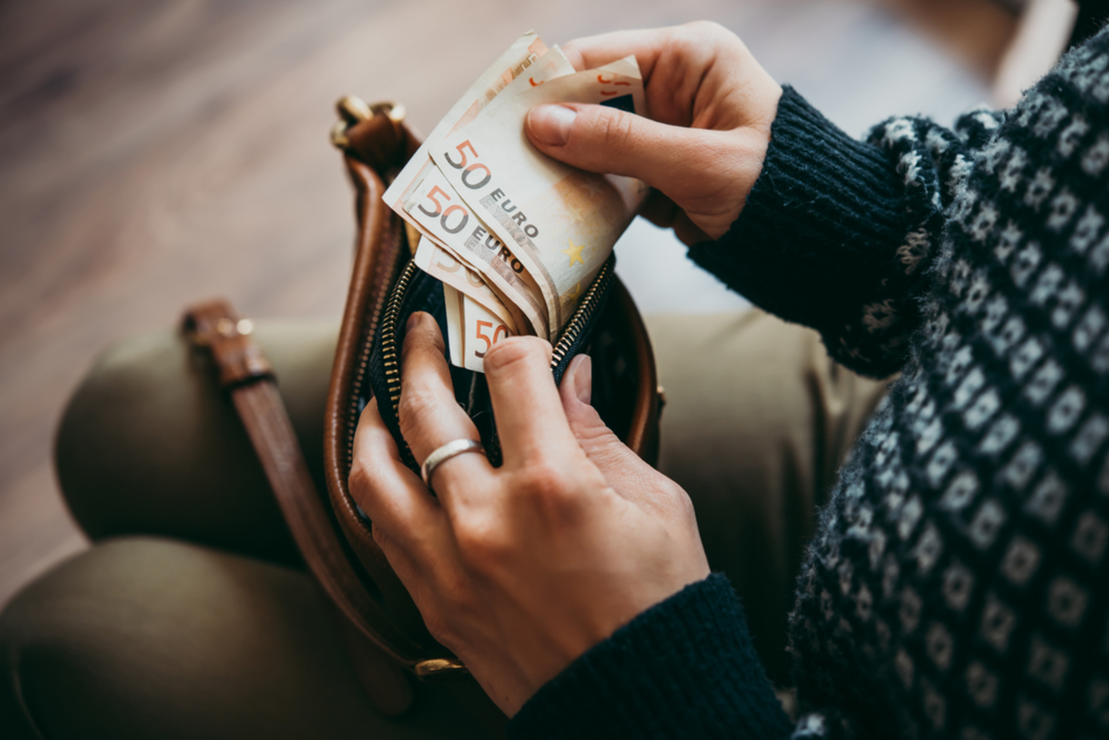 Girl’s,Hands,Holding,Euro,Bills,,Small,Money,Pouch,And,Leather