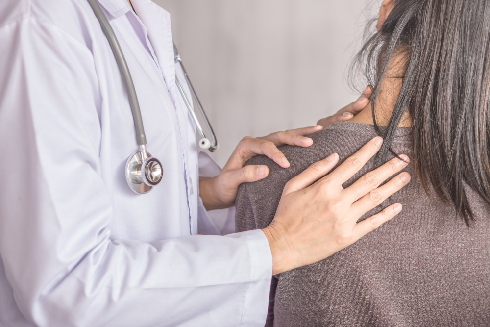 Female,Doctor,Examining,A,Patient,Suffering,From,Neck,And,Shoulder