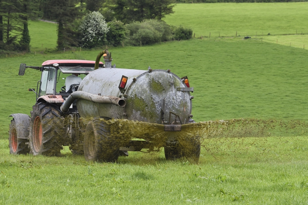 Farmer,Spreading,Slurry,In,Field