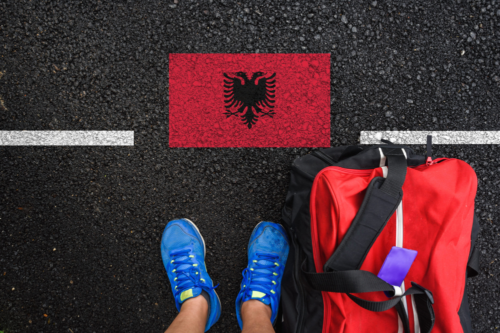 A,Man,With,A,Shoes,And,Travel,Bag,Is,Standing