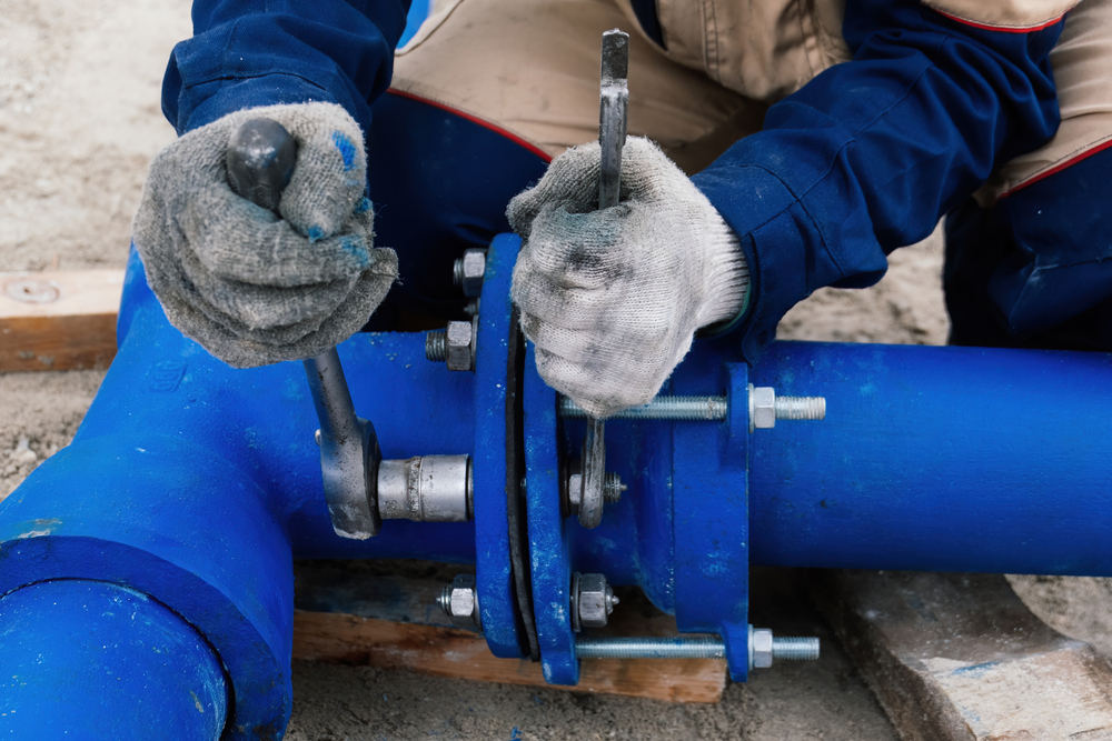 Workers,Installing,Water,Supply,Pipeline,System,,Close,Up